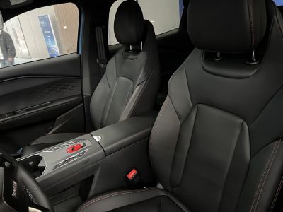 Black leather seats with red stitching and modern center console