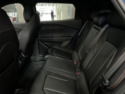 Black leather rear seats with modern door panel and stitching details