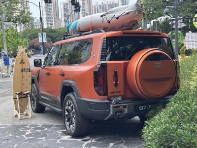 SUV with roof kayak and rear-mounted spare tire.