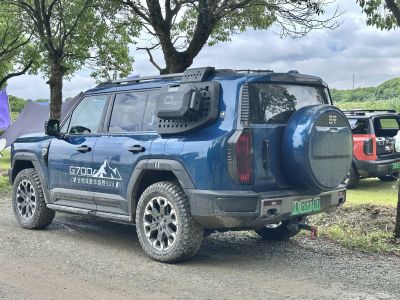 Blue off-road SUV with rugged tires and rear spare tire cover
