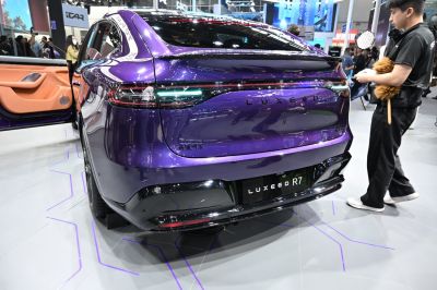 Sleek rear design with advanced tail lights and open door revealing interior