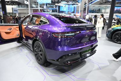 Sleek rear design with full-width taillights and open door showing premium interior