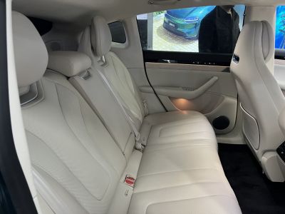 Beige leather rear seats with spacious, comfortable design and door panel details