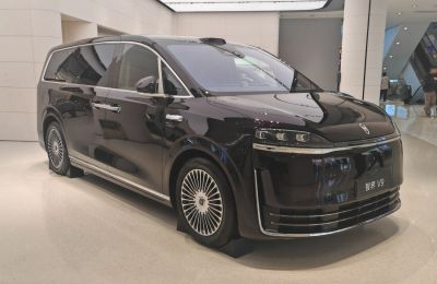 Front-side view of a sleek modern luxury MPV with distinctive LED headlights