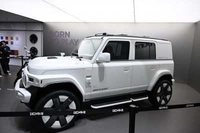Side view of boxy electric SUV with large wheels and roof rails