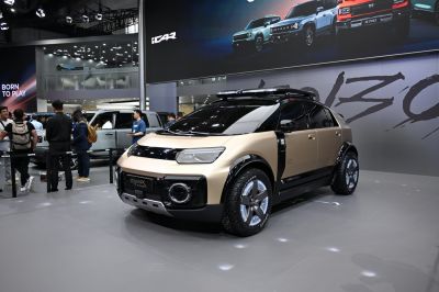 Futuristic SUV front fascia and rugged tires in auto show setting