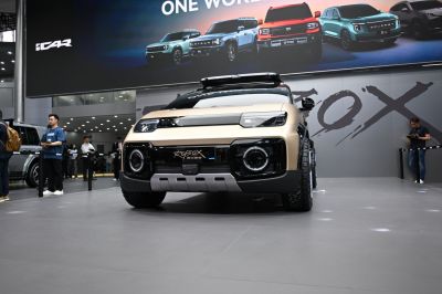 Rugged SUV front with circular headlights and off-road tires