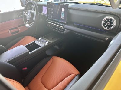 Digital dashboard and touchscreen in luxury SUV interior with leather seats and modern steering wheel