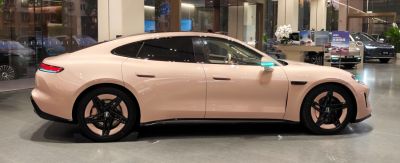 Sleek side profile with aerodynamic lines and black alloy wheels.