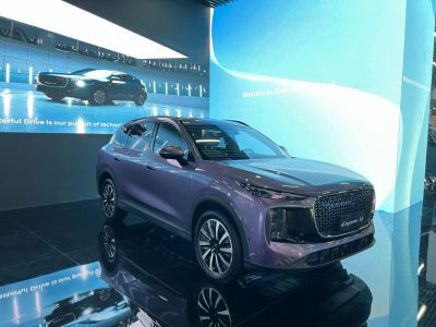 Large patterned grille with slim LED headlights on sleek SUV front