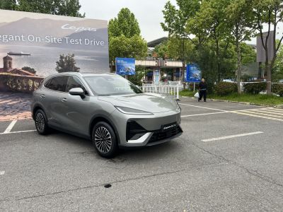 Sleek electric SUV front with aerodynamic lighting and alloy wheels