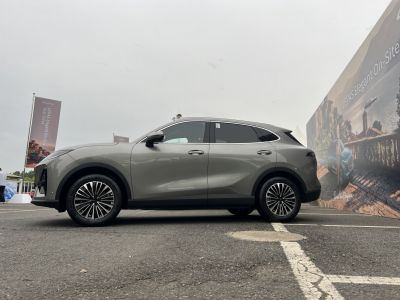 Side view of compact SUV with smooth curves and alloy wheels