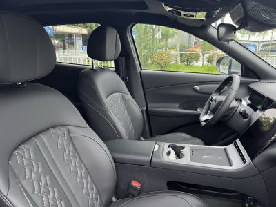 Black leather seats with diamond stitching and modern dashboard display