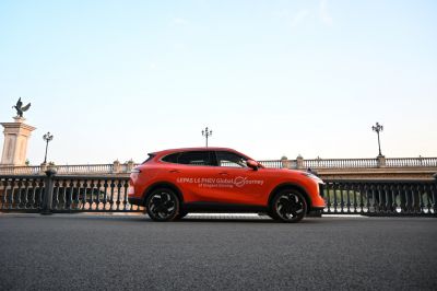 Side profile of orange mid-size suv with black wheels