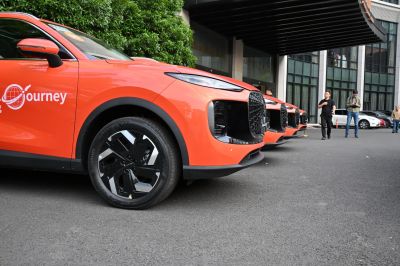 Distinctive front grille and alloy wheels on bright orange SUVs