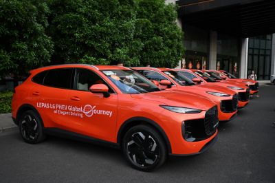 Bright orange PHEV SUVs with aerodynamic design and black grille.