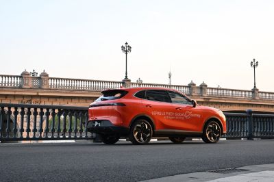 Orange coupe SUV side profile with tinted windows and modern wheels