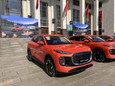 Bright orange SUV with large grille and narrow LED headlights
