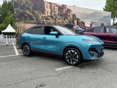 Sleek blue compact electric SUV shown from the side.