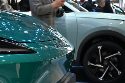 Close-up of sleek front design with headlights and badge