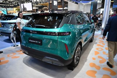 Rear view of green electric vehicle with LED taillights and modern styling