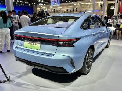 Rear view of a sedan with continuous LED tail light strip.