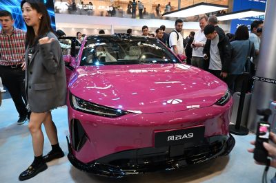 Sleek electric sedan front with modern LED headlights and aerodynamic design.