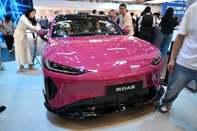 Sleek electric vehicle front with sharp LED headlights and aerodynamic design