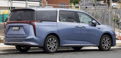 Rear side view of a minivan with LED tail lights and sliding doors