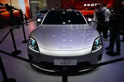 Sleek car front view with distinctive headlights and smooth hood.