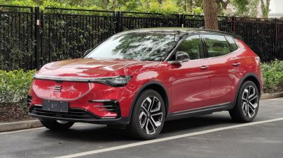 Red electric SUV with modern headlights and facelifted front design