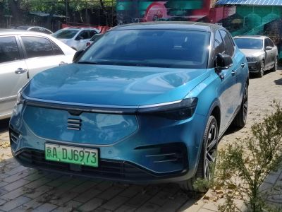 Sleek electric SUV front with closed grille and LED headlights