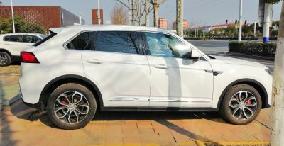 White SUV side profile with alloy wheels and sporty design