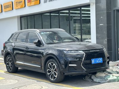 Front side view of SUV with angular grille and LED daytime running lights