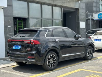 Rear side view of black SUV with alloy wheels and rear lights