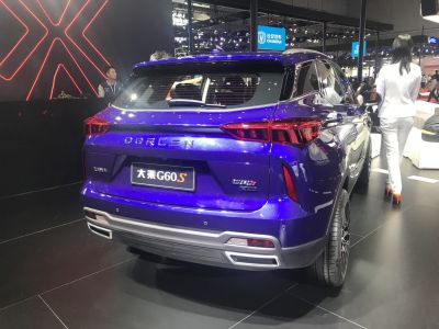 Rear view of a blue SUV with distinct taillights and dual exhaust design.