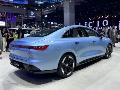 Rear and side view of a sleek electric sedan with LED light bar and aerodynamic lines
