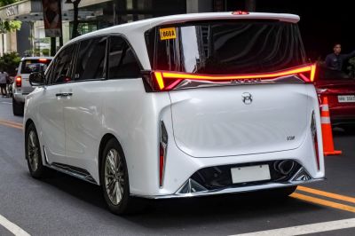 Rear view with futuristic LED light bar and sleek van design