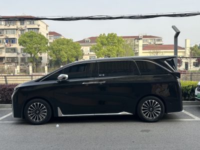 Side profile of sleek minivan with futuristic rear wing and stylish alloy wheels