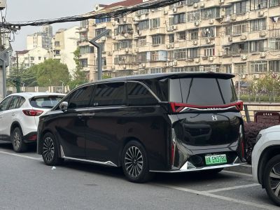 Rear view of black electric minivan with distinctive angular LED taillights
