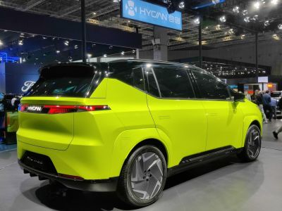 Rear view of electric SUV with sleek taillights and futuristic wheels.