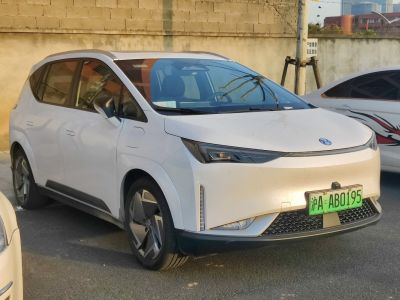 White vehicle with sleek LED headlights and smooth aerodynamic front design.