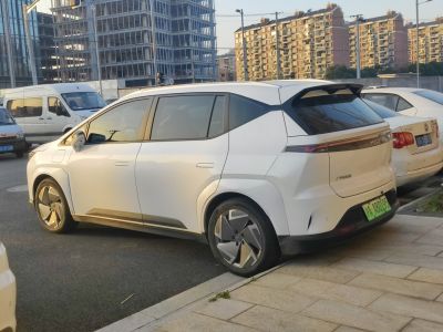 Rear side view of a white electric SUV with aerodynamic design and alloy wheels