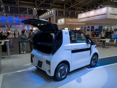 Compact hatchback with open rear hatch and modern wheels.