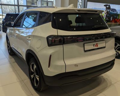 Rear and side view of white SUV with sleek taillights and alloy wheels