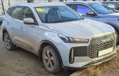 Modern compact SUV front and side view with large intricate grille