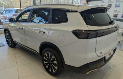 Rear side view of a white SUV with modern tail lights and sleek profile