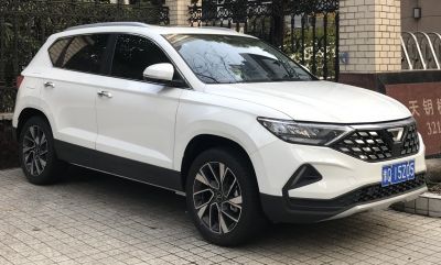 White modern SUV with angular headlights and detailed grille.