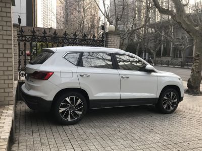 Side profile and alloy wheels of a white SUV with tinted windows