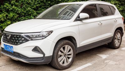 Sleek white SUV front side with modern headlights and alloy wheels